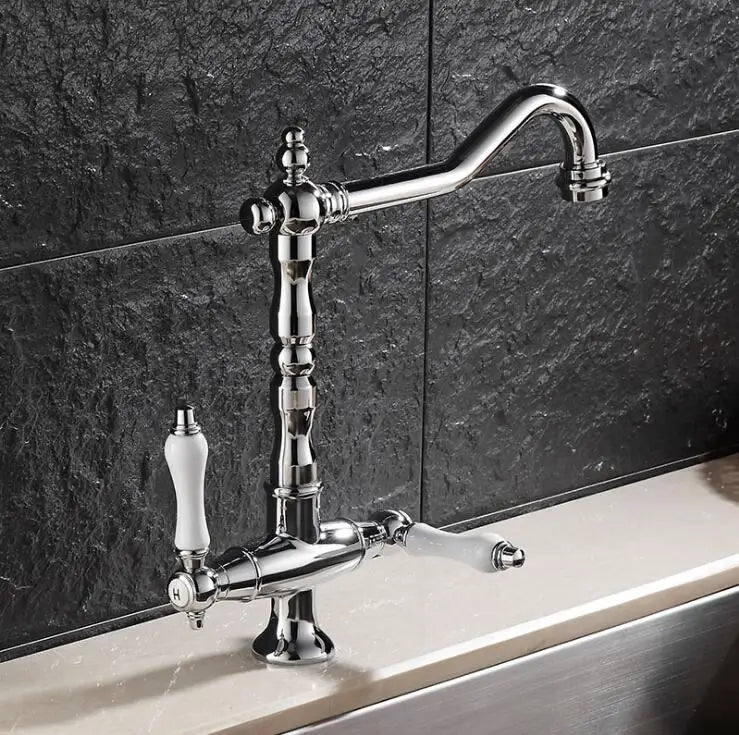 Chrome finished single hole kitchen faucet with elegant curved spout and two ivory ceramic handles for hot and cold water