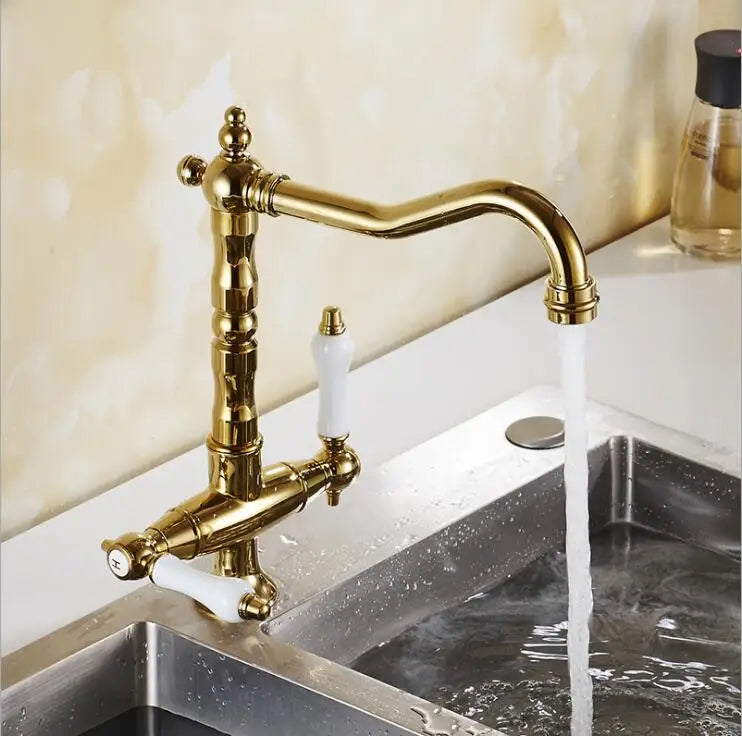 Brass-finished single hole kitchen faucet with white ceramic handles and 360 degree swivel for hot and cold water mixing