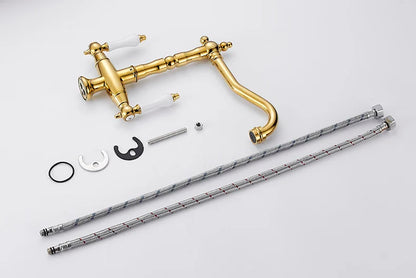 Gold-finished single hole farmhouse-style kitchen faucet with white ceramic handles and decorative scrollwork
