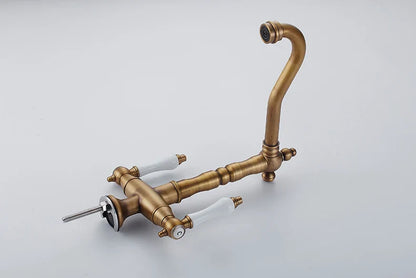 Antique brass single hole kitchen faucet with white ceramic handles and curved spout for swivel bathroom mixer