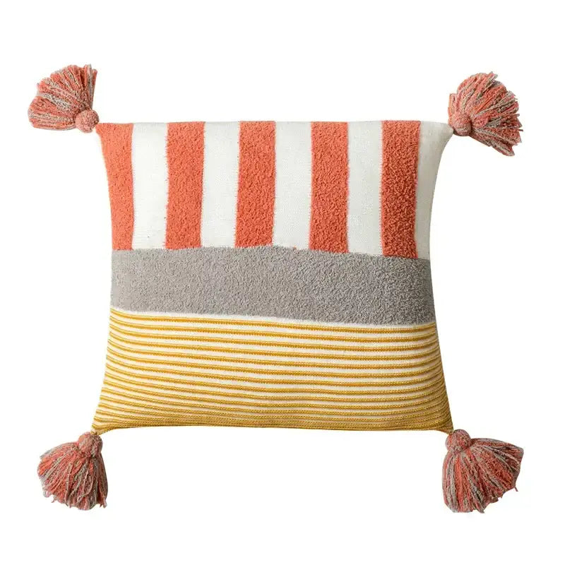A cozy knit stripe pillow cover in coral white with horizontal stripes and tassels for living room decorbites decor