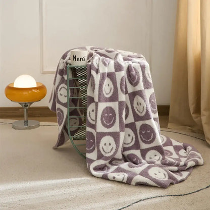 Decorbites knitted checkboard smile face throw blanket in purple and white with playful checkerboard pattern for bedroom decor