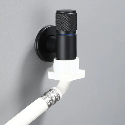 Knurled black copper brass washing machine faucet with black matte finish and blue accent connected to white pvc piping