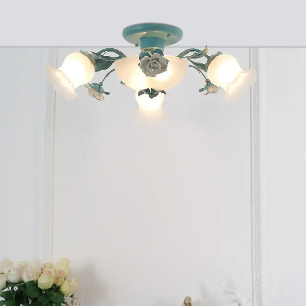 Teal floral ceiling light with frosted glass shades and painted metal arms for bedroom korean garden flower design