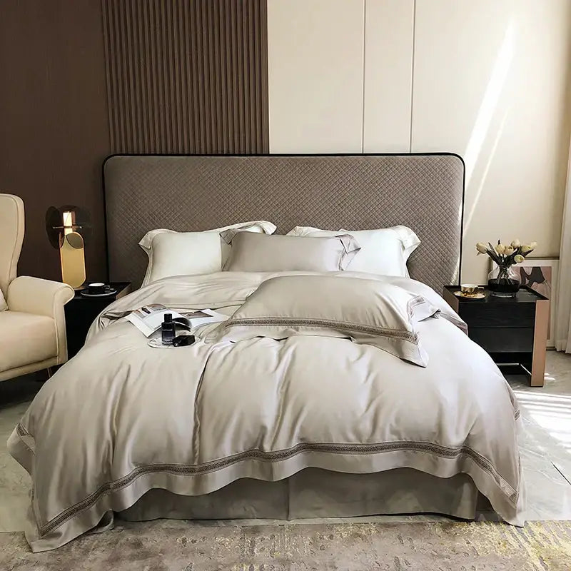 Beige satin bedding set with subtle embroidered trim made from decorbites eucalyptus lyocell luxury material
