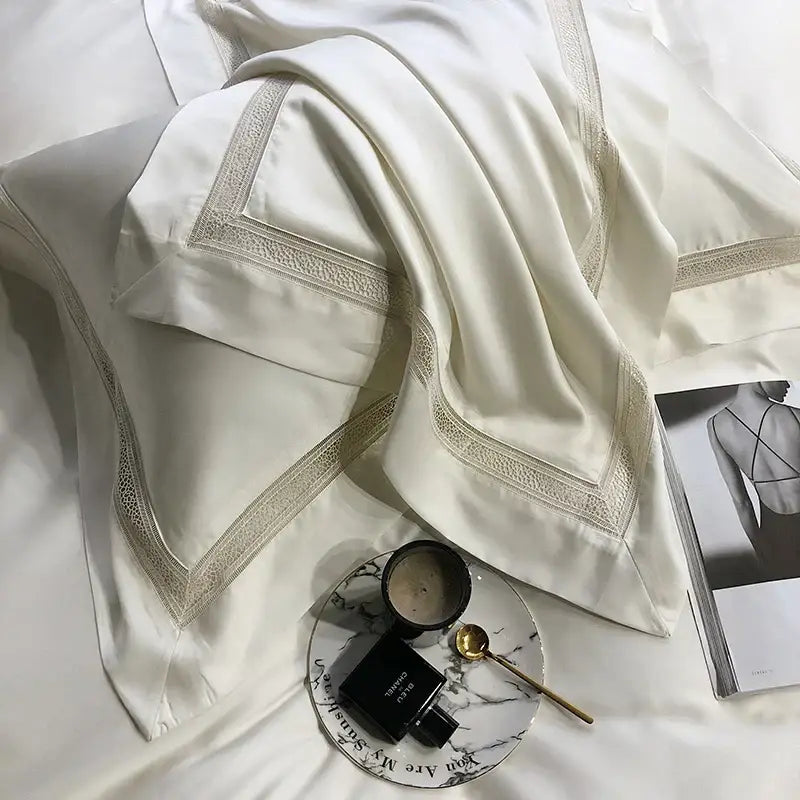 Cream-colored satin pillowcases with gold-toned lace trim from decorbites eucalyptus lyocell luxury bedding set