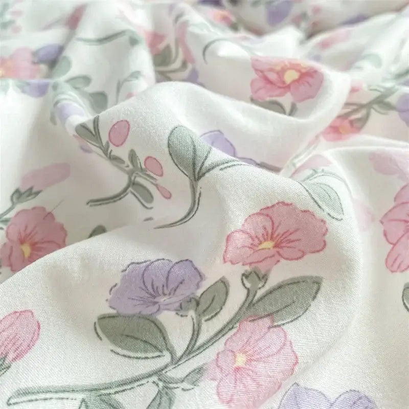 Soft white cotton bedding set with delicate pink and lavender flowers and green stems cozy pattern printed decorbites