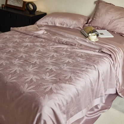 Lavender jacquard quilt set featuring a soft rose-gold satin duvet cover with subtle bamboo leaf pattern decorbites light luxury