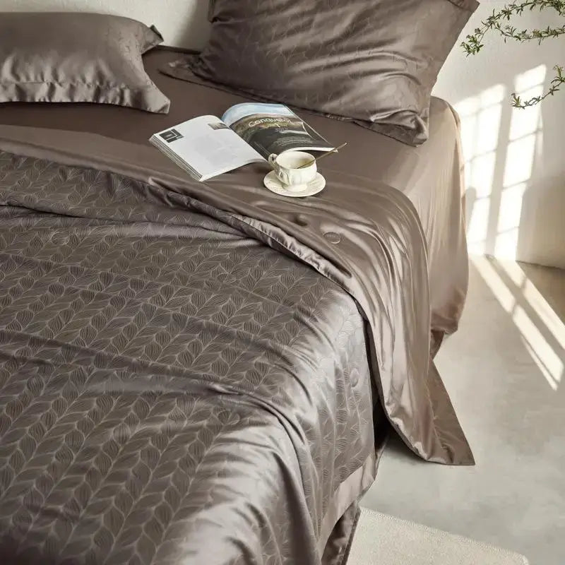 Luxurious taupe satin quilt set with subtle leaf pattern ruffled edges and matching pillowcases for decorbites light luxury bedding
