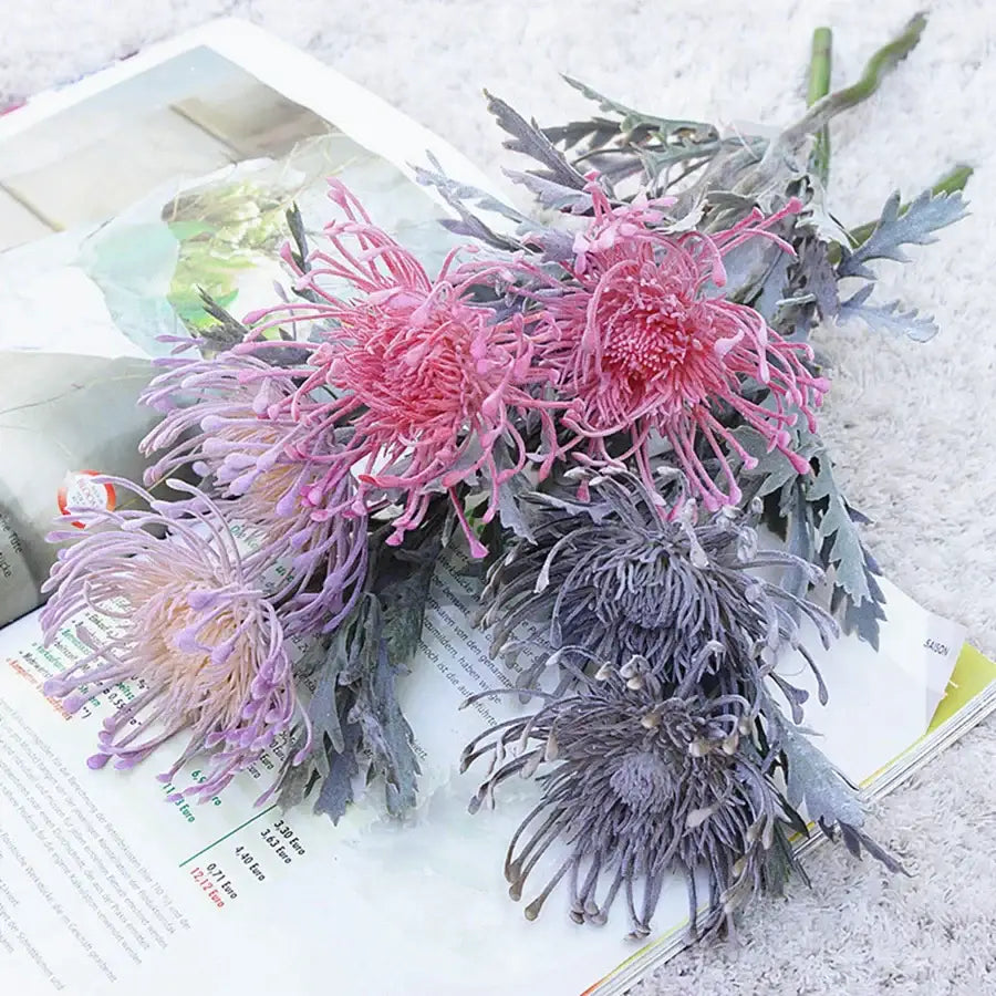 Lavender and orange decorbites artificial crab claw branch with pink and purple spiky flowers and grayish green leaves