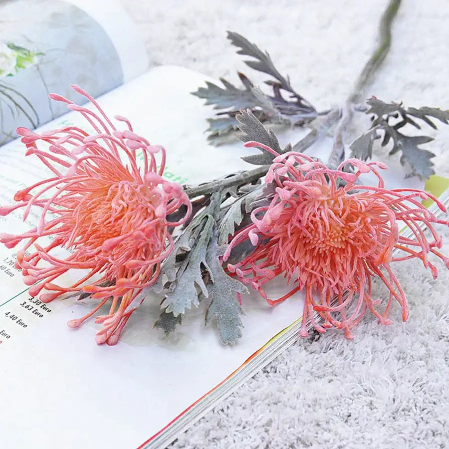 Lavender and orange artificial crab claw branch with pink and orange protea flowers and frosted gray leaves decorbites artificial crab claw decor