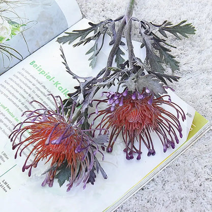 Lavender and orange artificial crab claw branch with red and purple protea flowers and gray-green foliage for decorbites artificial crab decor