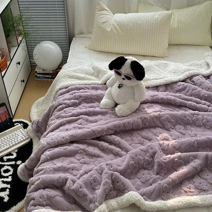 A plush lavender and white cozy lamb wool flower throw blanket with soft textured surface and fleece trim for decorbites cozy lamb decor