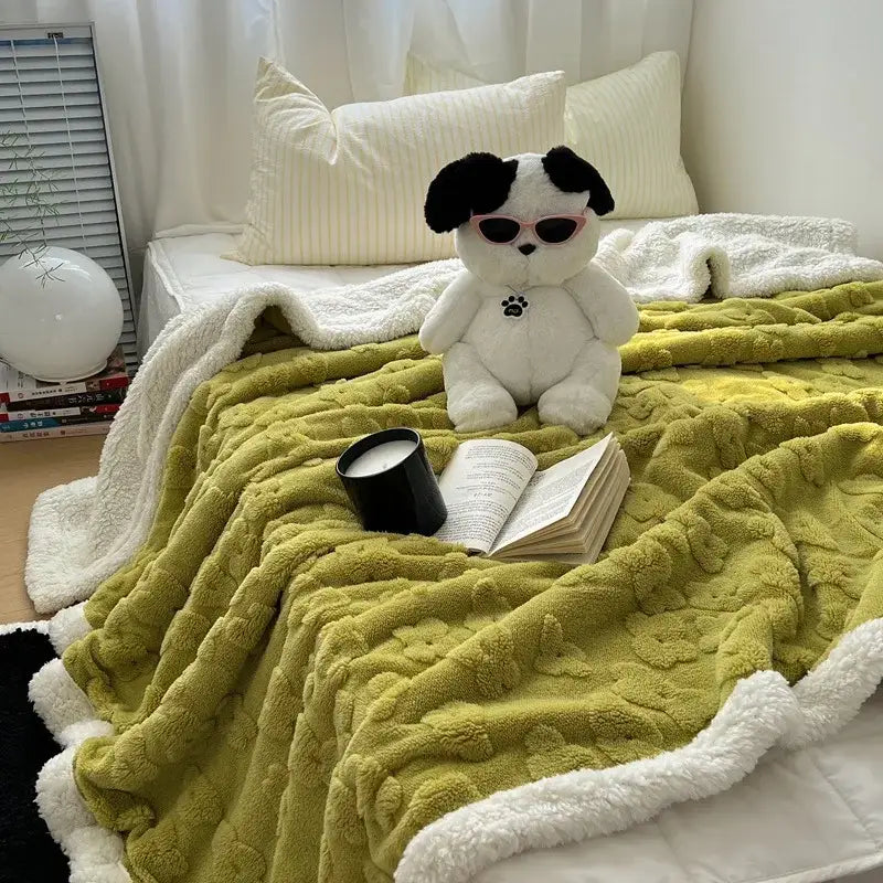A plush dog toy with pink sunglasses sits on a lavender and white cozy lamb wool flower throw blanket for decorbites cozy lamb