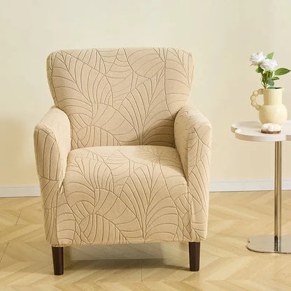 Beige leaf pattern jacquard elastic chair cover with textured fabric and dark wooden legs for dining room chairs