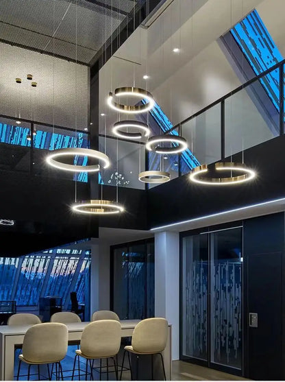Modern led chandelier light with gold metallic circular frames and glowing white led rings for dining room or kitchen