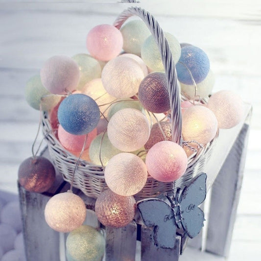Led cotton ball lights featuring pastel-colored cotton balls with butterfly accents in a white wicker basket