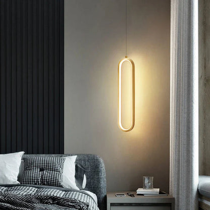 A sleek black gold led pendant light with a minimalist oval design and warm golden glow for indoor decor
