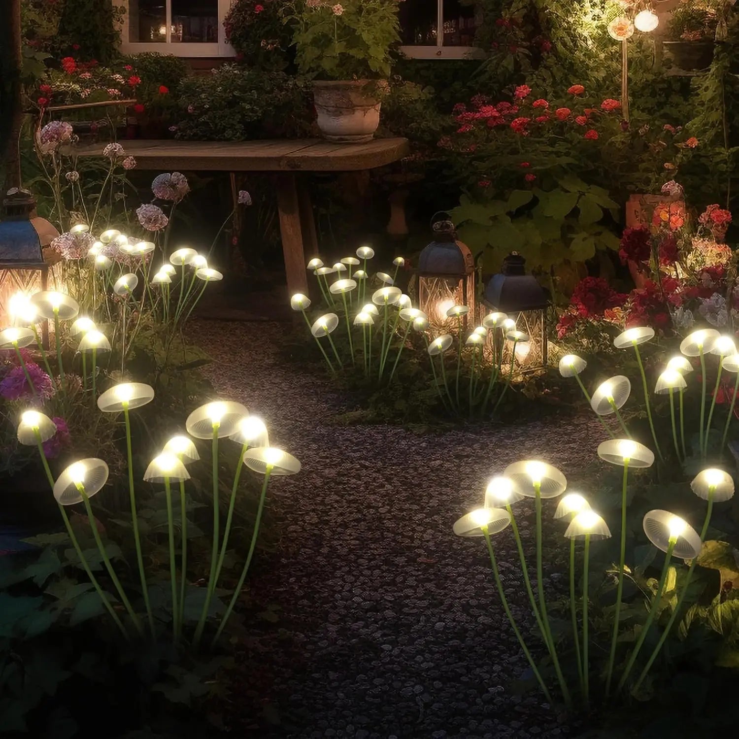 Led solar jellyfish mushroom lamp with glowing translucent caps and slender green stems along a gravel path for outdoor garden lighting