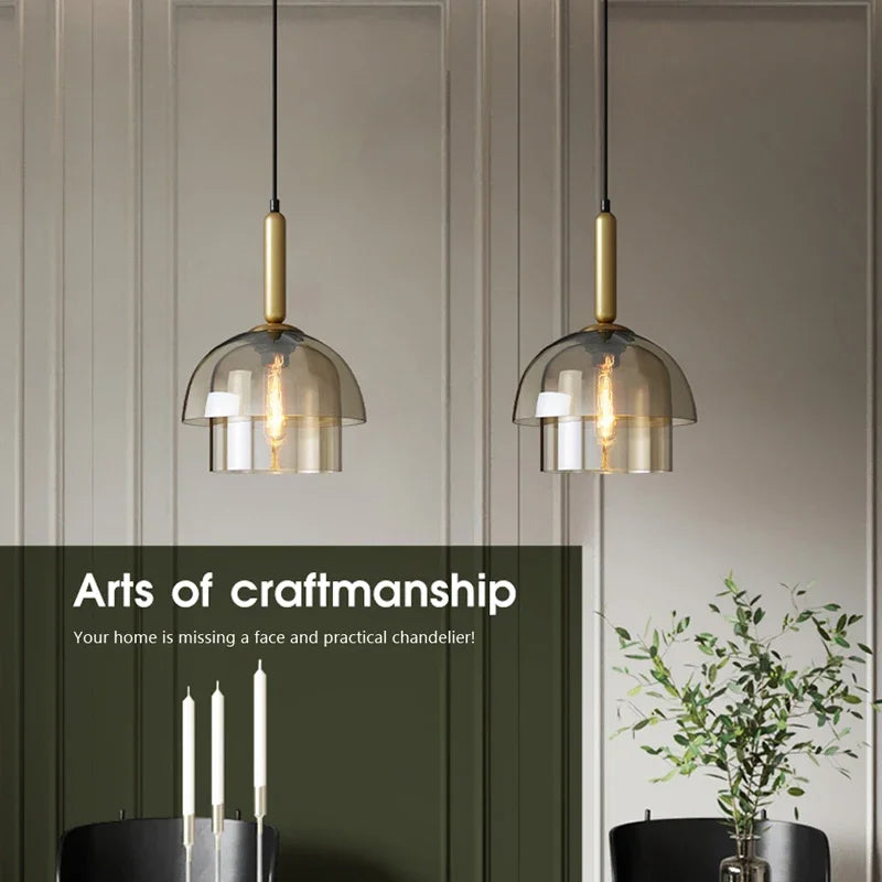 Two modern LED vintage art champagne pendant lamps with gold metal fixtures and smoked glass domes for bar decor