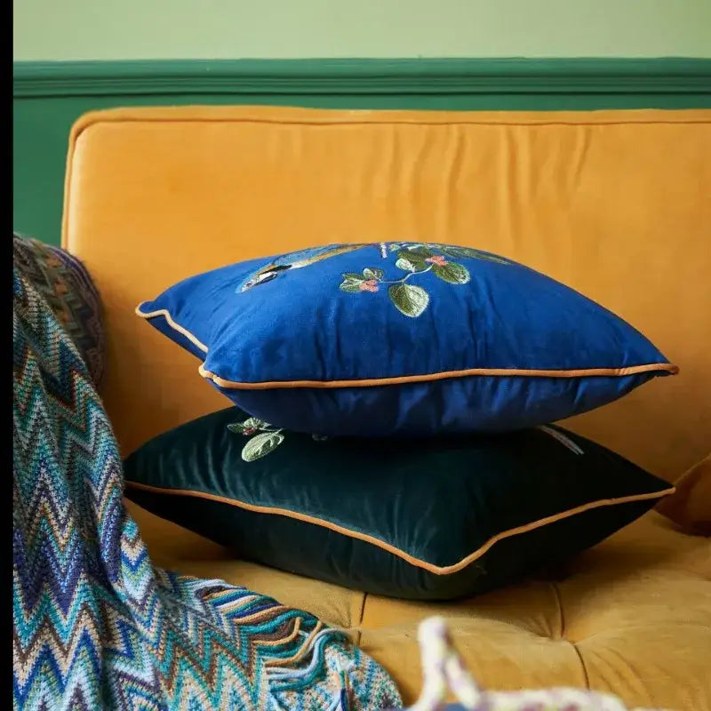 Blue velvet decorative pillowcase featuring leopard embroidered floral design and gold piping for living room decorbites