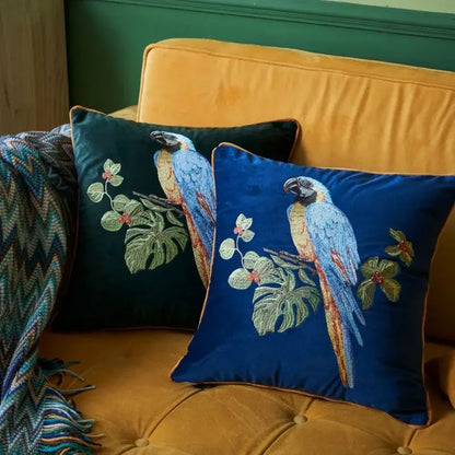 Deep blue velvet decorative pillowcase with intricately embroidered macaws and tropical leaves in teal and gold decorbites leopard embroidered style
