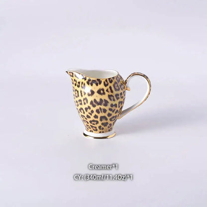 A delicate porcelain creamer with golden leopard print and gold-trimmed handle in decorbites leopard print coffee set