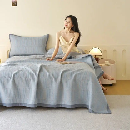 Light blue and gray decorbites cotton summer cool quilt with textured grid pattern and matching towel blanket pillowcases