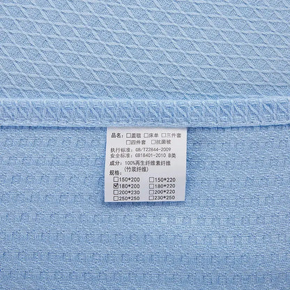 Light blue bamboo fiber summer quilt with textured woven pattern and white care label for bedroom use decorbites bamboo fiber