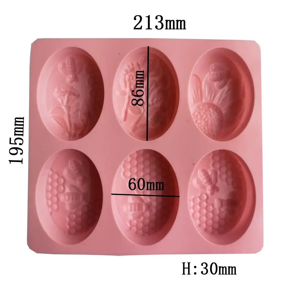 Pink silicone egg-shaped soap mold with intricate floral and bee designs for bee silicone soap making