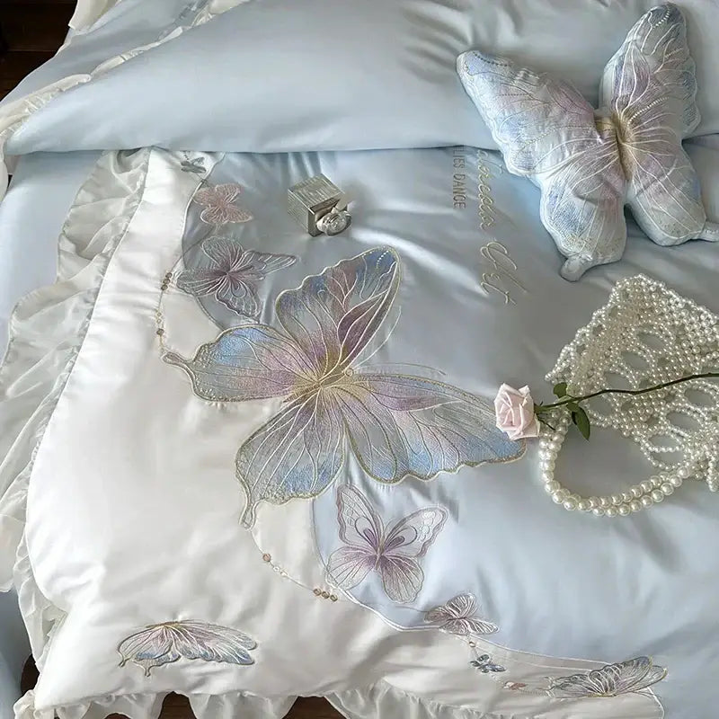 Light blue satin bedding set with delicate butterfly embroidery and ruffled edges featuring decorbites french lace