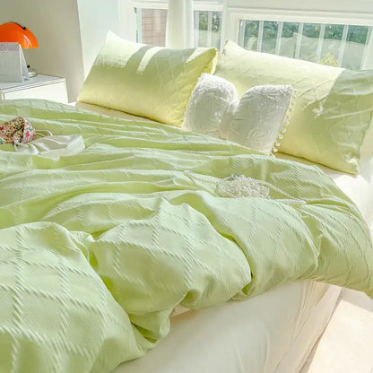 Light green textured duvet cover with subtle diamond-patterned weave in light blue diamond grid jacquard bedding set