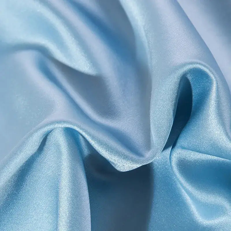Light blue satin fabric with a smooth glossy finish and gentle folds in 200s cotton embroidery bedding set
