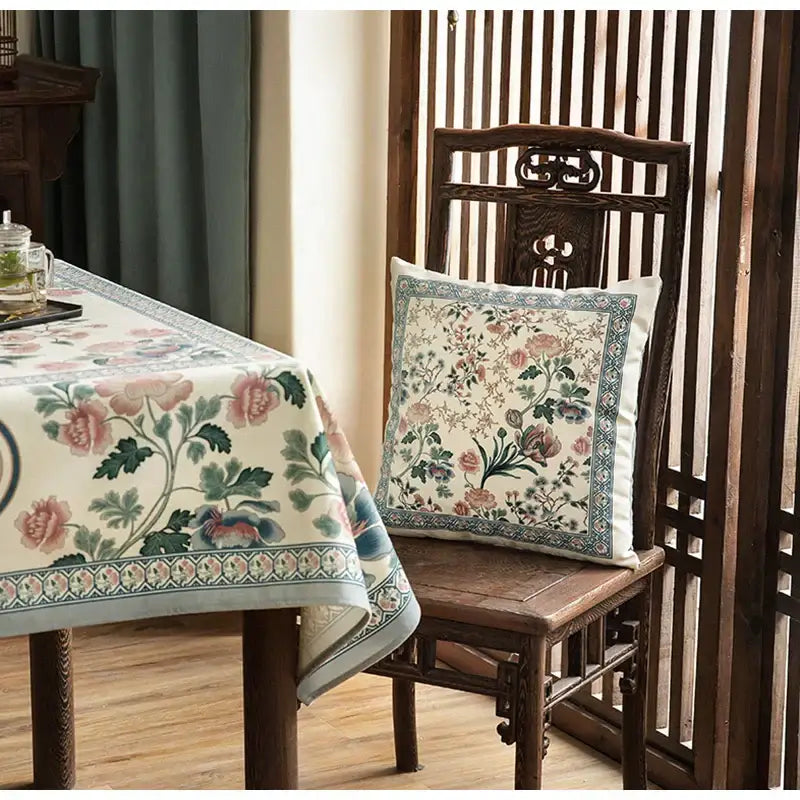 A light blue flower fragrance pillow cover with a delicate floral pattern in soft pinks greens and blues on off-white