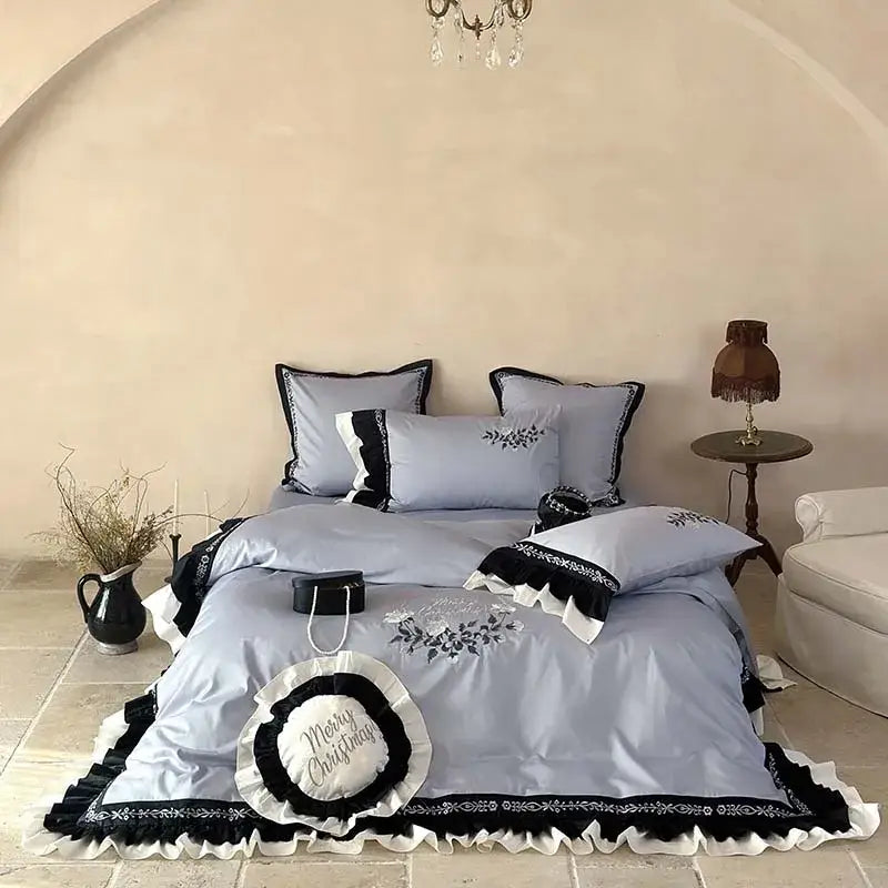 Light blue satin bedding set with black and white flowers embroidery ruffles and a merry christmas pillow accent