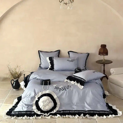 Light blue satin bedding set with black and white flowers embroidery ruffles and a merry christmas pillow accent