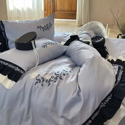 Light blue satin bedding set with black decorbites flowers embroidery and ruffles trim for elegant bedroom decor