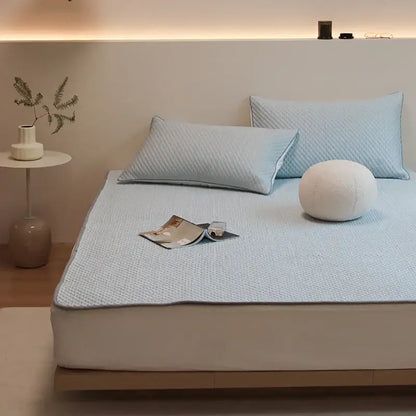 Light blue quilted bed sheet set with subtle textured pattern and plush finish for cooling sleep by decorbites ice bean