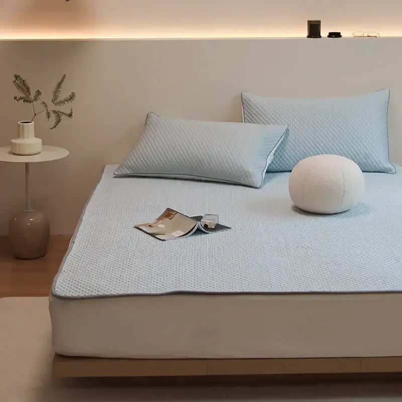 Light blue quilted bed sheet set with subtle textured pattern and plush finish for cooling sleep by decorbites ice bean