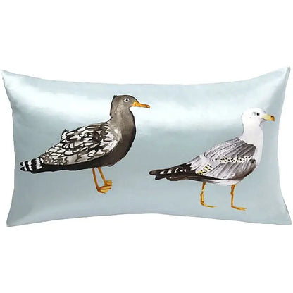 Light blue paradise silk throw pillow cover featuring watercolor seagulls in a living room silk throw pillow design