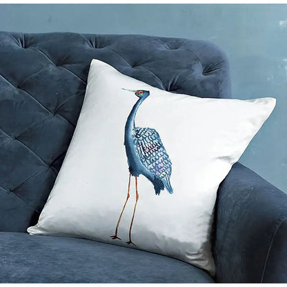 White paradise silk throw pillow cover featuring detailed blue crane embroidery with iridescent feathers and orange legs