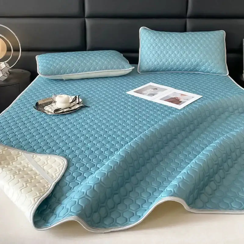 Light blue hexagonal cooling latex filled bed mat with quilted honeycomb texture and white piping edges for bedroom use