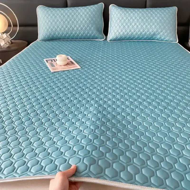 Light blue hexagonal-patterned latex filled bed mat set with cooling properties including matching pillow covers