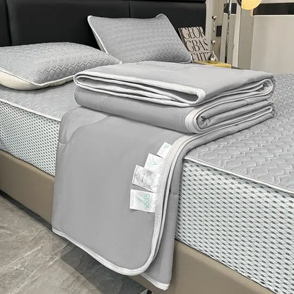 Gray quilted blanket with white piping and care tags in decorbites cool feeling ice silk quilt set for bedroom bedding