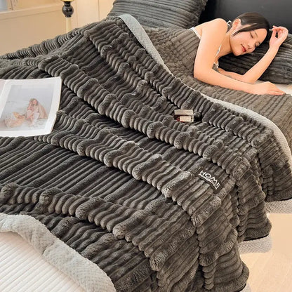A dark gray corduroy throw blanket with soft fleece lining and ribbed texture from decorbites cozy faux rabbit plush collection