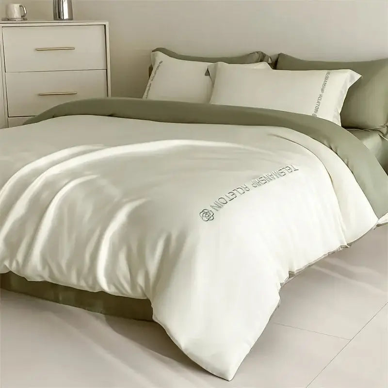 Cream-colored satin duvet cover with olive green piping and decorbites cotton embroidery bedding set logo detail