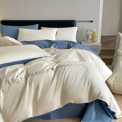 Light blue satin embroidery bedding set featuring a cream satin duvet cover with subtle light luxury embroidery in gray thread