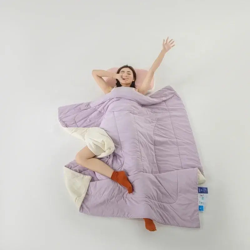 Lavender quilted comforter with cream-colored lining made from decorbites cooling fabric for summer bedroom use