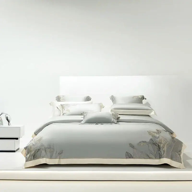 Light gray eucalyptus lyocell soft bedding set with delicate leaf embroidery and cream-colored piping for bedroom decor