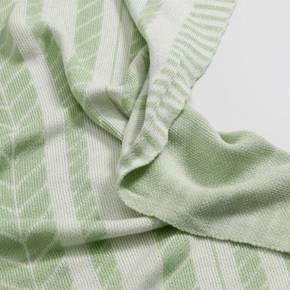 Light green and white striped bamboo knitted cooling blanket with soft textured weave from decorbites for bedroom use